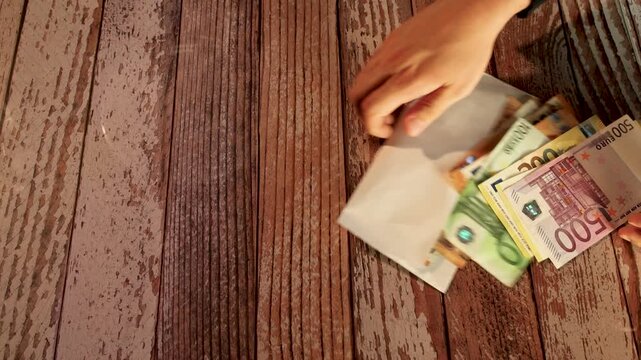 throwing euro banknotes on table