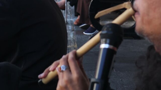 defocus musician playing bamboo flute  from West Java