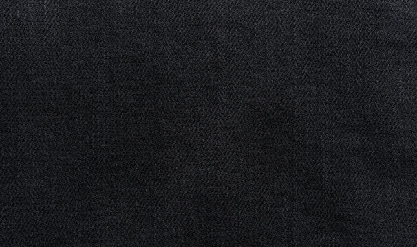 Black denim background, dark jeans fabric macro texture