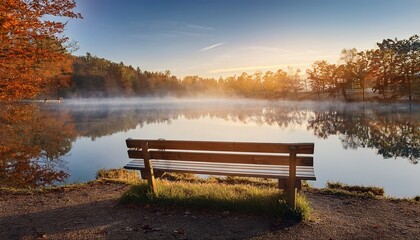 Fototapeta premium A Serene Wooden Bench Overlooking A Misty Lake On A Quiet Autumn Morning Symbolizing Peace And Reflection For World Mental Health Day