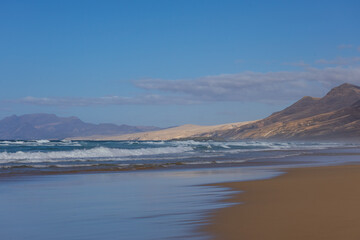 Fototapeta premium Long Wide Angle View of Deserted Cofete Beach in Fuerteventura Sunlight