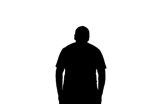 A dark, solid silhouette of a man standing still, isolated on a pure white background. This minimalist image is perfect for conceptual designs representing anonymity, identity, or a human profile.