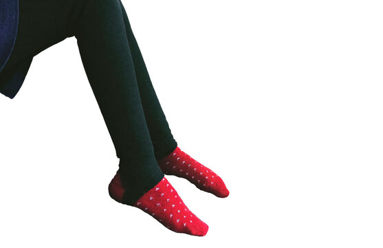 A pair of legs in black tight leggings and red socks with a white pattern, isolated on a clean white background. Perfect for fashion, comfort, or lifestyle themes.