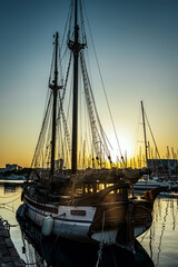 Traditional wooden sailing ship rigging silhouetted at sunset in Barcelona marina © keizo0211