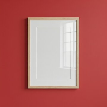 Blank vertical photo frame mockup with wooden border hanging on red wall background, interior