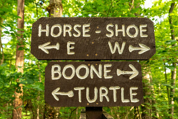 Wooden trail sign marking hiking routes through the forest at French Creek State Park, Pennsylvania. © Nicola