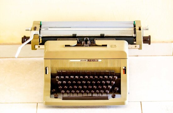Brazil, December 26, 2016: close-up of a vintage Olivetti Linea 88 mechanical typewriter in beige color, featuring a full QWERTY keyboard, paper carriage, and tabulator keys, showcasing classic Italia