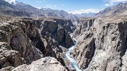 Fototapeta premium Deep rocky canyon with a turquoise river winding through the gorge, Afghanistan