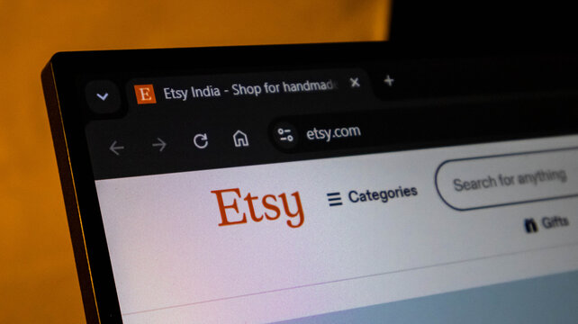 Etsy website displayed on a laptop screen. Online marketplace homepage viewed on a computer browser. Small business e-commerce platform for handmad...