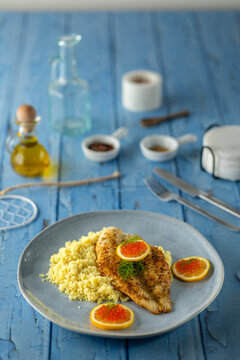 Grilled fish fillet with couscous, caviar, and fresh lemon
