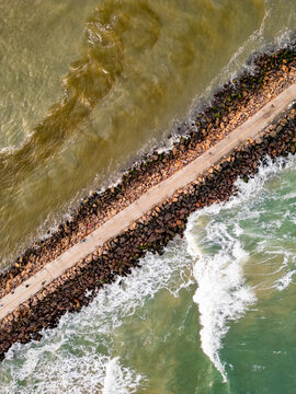Top-Down Drone View of the Jetty with People Walking Between the Sea and the River in Torres, Brazil