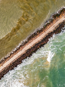 Top-Down Drone View of the Jetty with People Walking Between the Sea and the River in Torres, Brazil