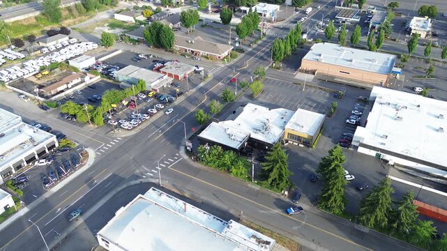 Urban storage cluster arterial roads intersect near sprawling Kent industrial complexes. White commercial rooftops occupy most of the visible land, reflecting high logistical density found in WA
