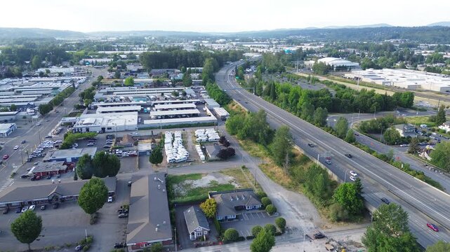 Industrial infrastructure layout interstate 167 curves beside clustered commercial zones within Kent valley. asphalt arterials weave between building arrays, reflecting high traffic logistics, WA