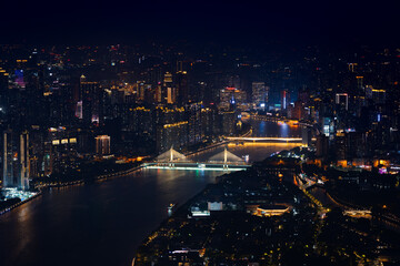 Fototapeta premium Chongqing city skyline at night with river and bright bridges