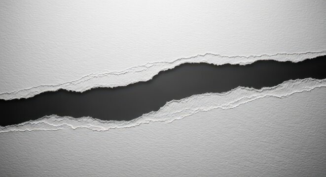 A macro shot of thick white textured paper showing a jagged irregular tear through the center against a contrasting dark grey background, isolated, fragment, torn