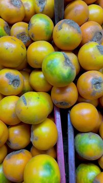 Full frame close up of fresh organic lulo naranjilla exotic tropical fruit pile