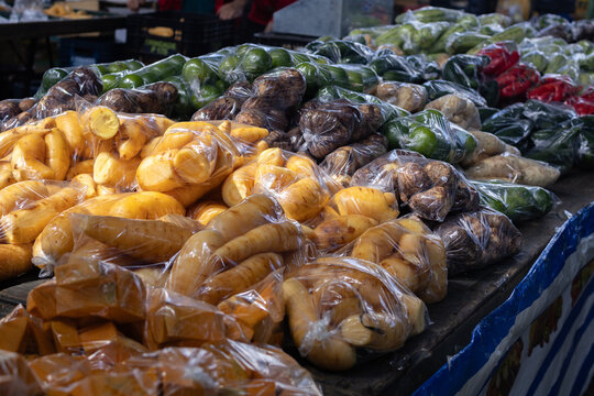 Fresh Root Vegetables and Tubers Pre-Packaged in Plastic Bags at Local Market
