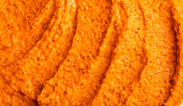 Orange yogurt ice cream with fresh fruits and berries, papaya, grapefruit, pumpkin, persimmon. Smoothie texture. Fruit yogurt ice cream. Delicious sweet dessert close-up as a background.