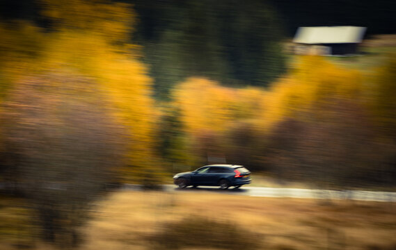 Modern Station Wagon Driving Through Autumn Landscape with Motion Blur &ndash; Panning Shot