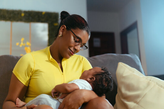 Mother embracing newborn baby son with love