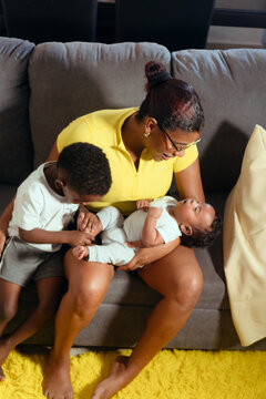 Mother bonding with children and newborn baby