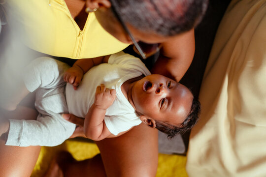 Mother holding newborn baby boy showing care and love