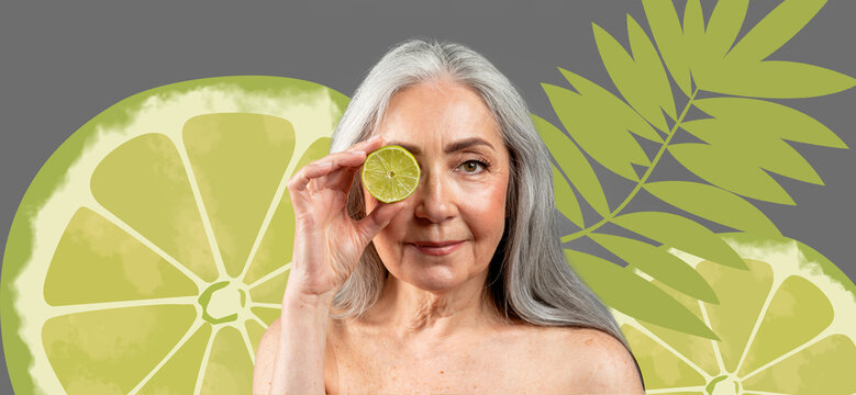 Smiling Senior Woman Holding Lime Slice In Front Of Eye, Radiating Joy And Positivity While Promoting Healthy Lifestyle Choices. Indoor Setting With Decorative Plant In Background, Wellness Concept.