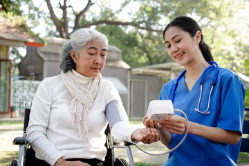 Fototapeta premium A woman in a white shirt is being checked by a nurse