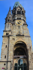 Obraz premium Kaiser Wilhelm Memorial Church is one of Berlin Germany most famous landmarks. The damaged tower is a symbol of Berlin's resolve to rebuild the city