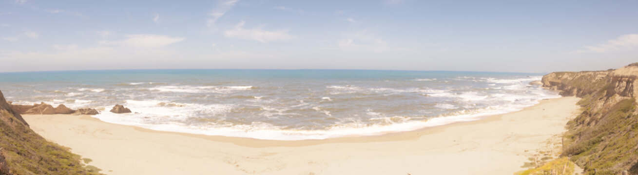 Panoramic view of coastal cliffs and sandy beach along the Cental California coastilne