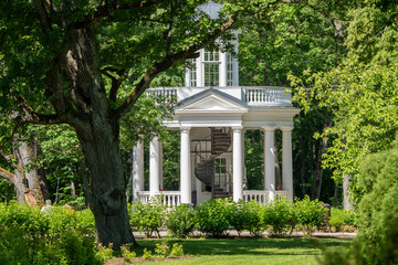 Obraz premium Elegant White Park Pavilion Nestled in Rich Green Summer Forest