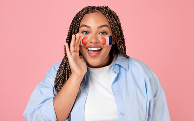 Fototapeta premium Smiling Young Woman With French Flag Face Paint Celebrating With Joyful Expression At Studio, Enjoying Fun Atmosphere And Spirit Of Celebration. Perfect For Event And Festivity Concept.