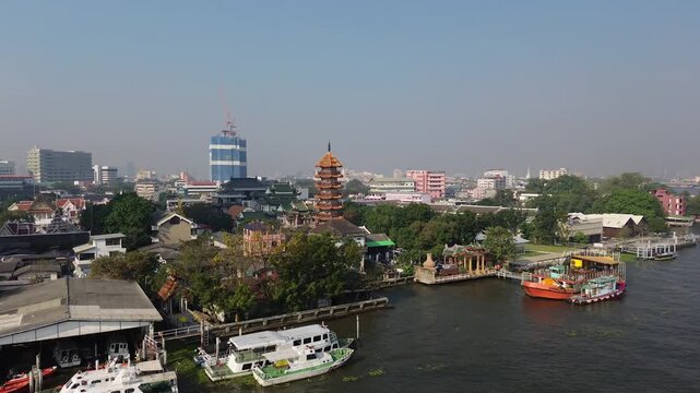 Aerial view of Wat Che Chin Koh temple tower and Chao Phraya river, Bangkok, Thailand, 4k