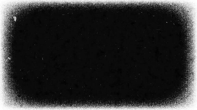 White vintage film frame seamless loop animation with stop motion dust particles and grunge border on black background. 4K animated old film texture effect for vintage video editing and retro overlay.
