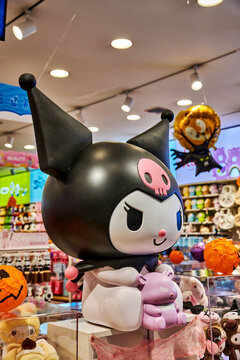 Ambato, Ecuador - October 28, 2025: Large decorative store display statue of popular Sanrio anime character Kuromi holding her purple sidekick Baku, toys and Halloween decorations in colorful store.