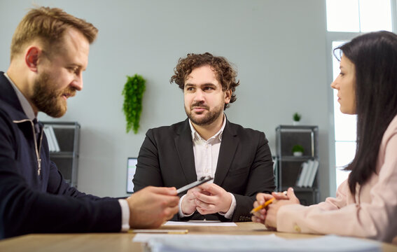 Interview recruiter with candidate and manager hiring discussion. Team meeting at desk reviewing terms, agreement and approval for employment contract. Hiring approval concept for HR.