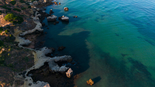 serene rocky coastline aerial view still scene natural landscape travel nature blue green clean background copy space editorial educational visual story design resource web banner poster.