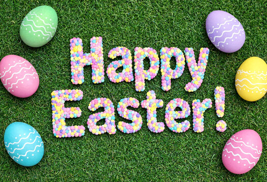 Colorful happy easter greeting with decorated eggs on green grass background perfect for celebration