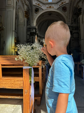 Curious child exploring decorated church before wedding.