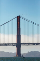 Obraz premium Architectural detail view of Golden Gate Bridge tower’s art deco style, international orange color, and many rivets