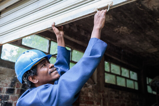 Worker opens a garage workshop door