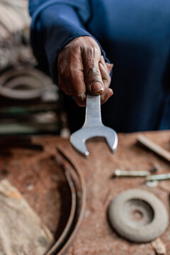 Closeup of worker holding a wrench in a workshop