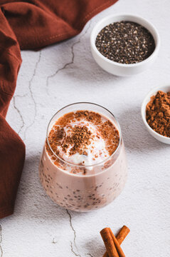 Healthy breakfast overnight oats and chia in a glass on the table vertical view