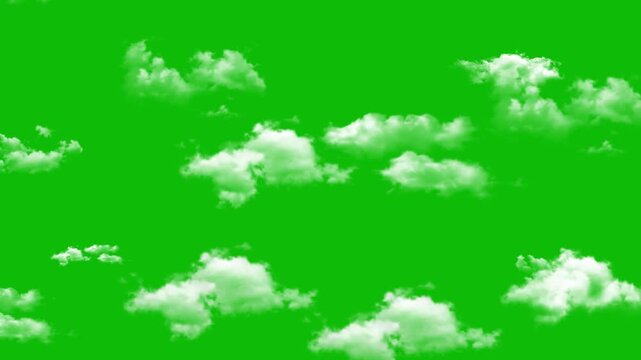Group of small white clouds floating in the sky against a solid green screen for easy background removal greenscreen chroma key