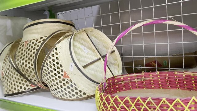 Traditional Indonesian handmade bamboo fruit baskets with handle displayed on shelf