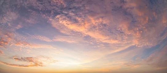 Beautiful sunset sky background with soft pastel pink purple clouds and vibrant golden orange sun glow for panoramic travel mockup design © Choat