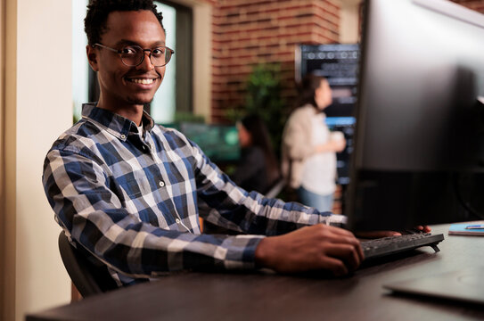 African american developer working on software program in it programming agency, utilizing skills in coding and technology to create more inclusive program, web programer writing html script.
