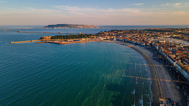 Scenic drone view of bay coastline and isle of portland on horizon