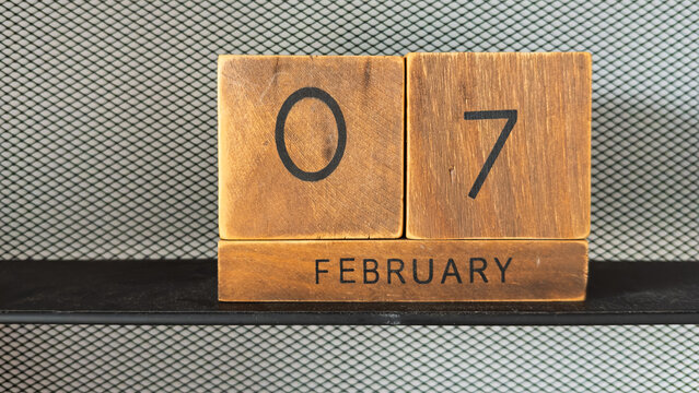 Wooden blocks with months of the year for date concepts with February 7th showing